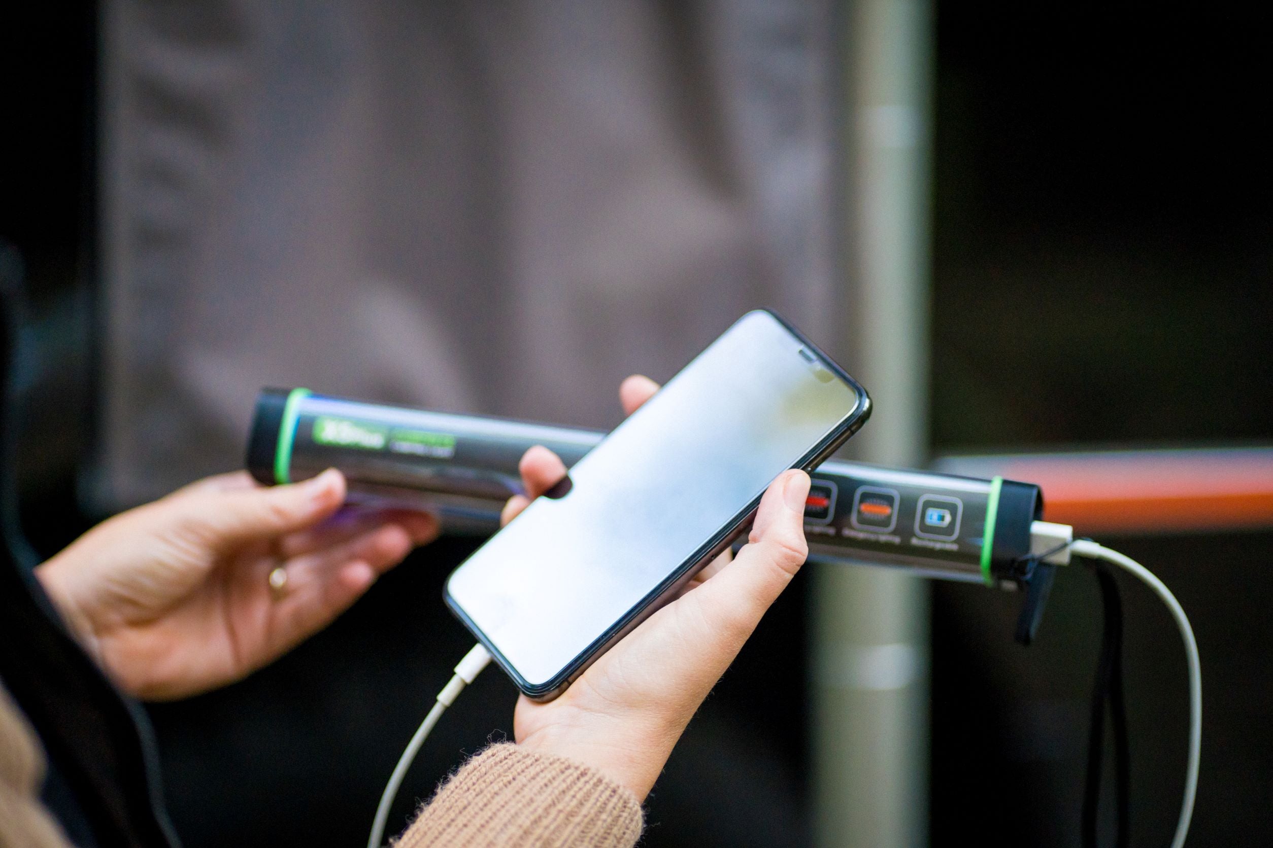 LED Power Bank Utility Torch Charging an iPhone